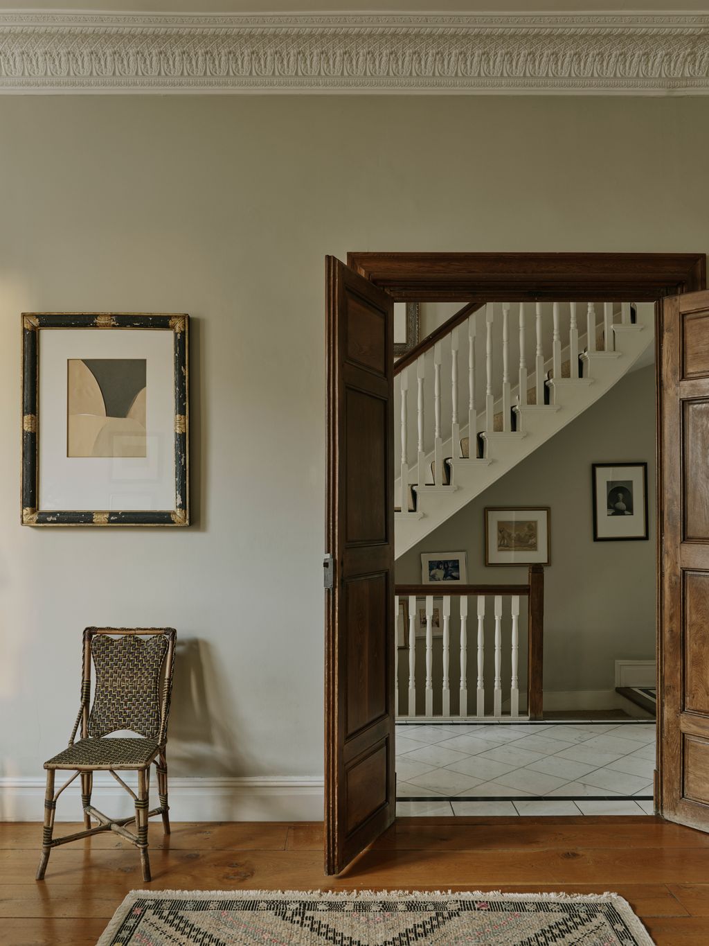 Image may contain Architecture Building Foyer Indoors Home Decor Rug Interior Design House Housing and Staircase