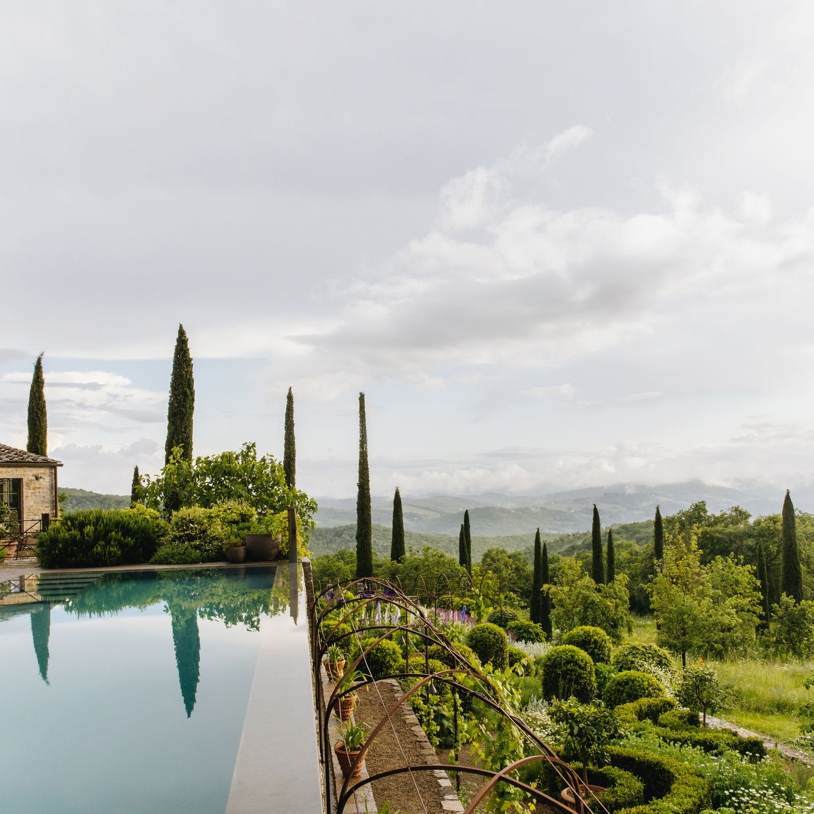 A farmhouse garden in the Chianti hills of Tuscany that blends the local vernacular with an English sensibility